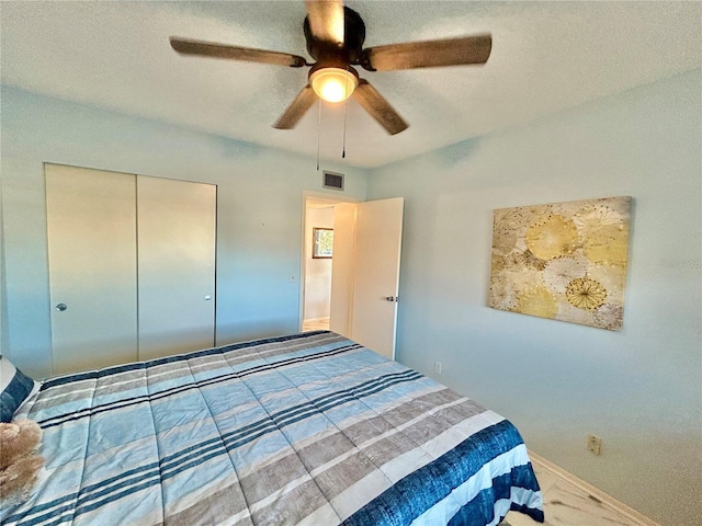 bedroom with ceiling fan, carpet floors, and a closet