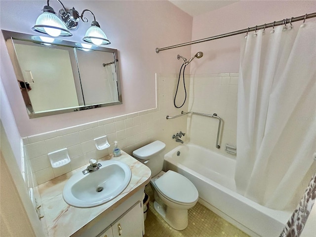 full bathroom with toilet, shower / tub combo, tile walls, vanity, and tile patterned flooring