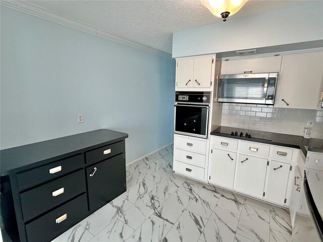 kitchen featuring white cabinetry, ornamental molding, black appliances, a textured ceiling, and decorative backsplash