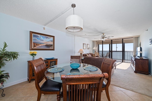 dining room with light tile patterned floors, floor to ceiling windows, a textured ceiling, and ceiling fan