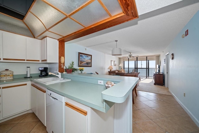 kitchen featuring white cabinetry, dishwasher, kitchen peninsula, and light tile patterned floors