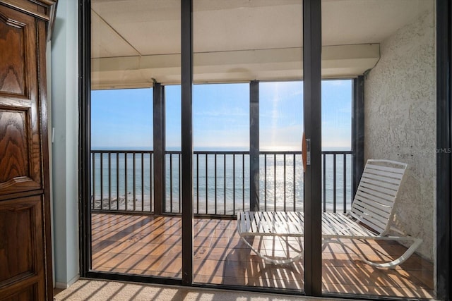 balcony featuring a water view and a view of the beach