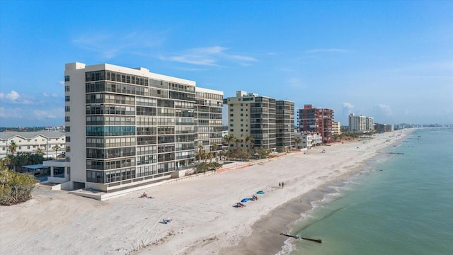 view of property with a water view and a view of the beach