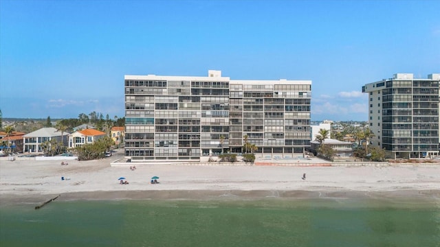 view of building exterior with a view of the beach and a water view