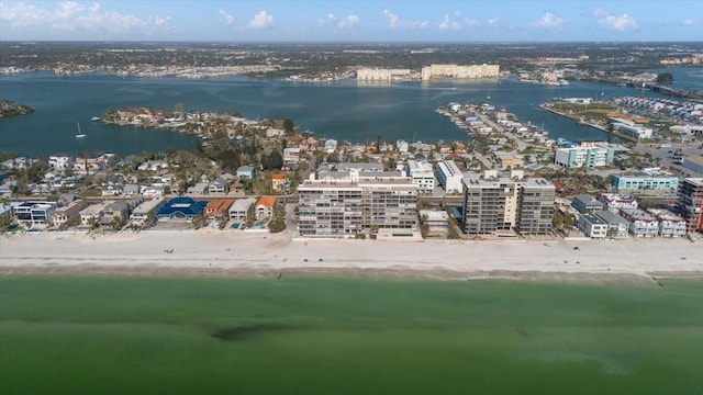 birds eye view of property with a water view and a beach view