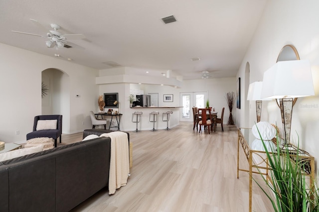 living room featuring ceiling fan and light hardwood / wood-style floors