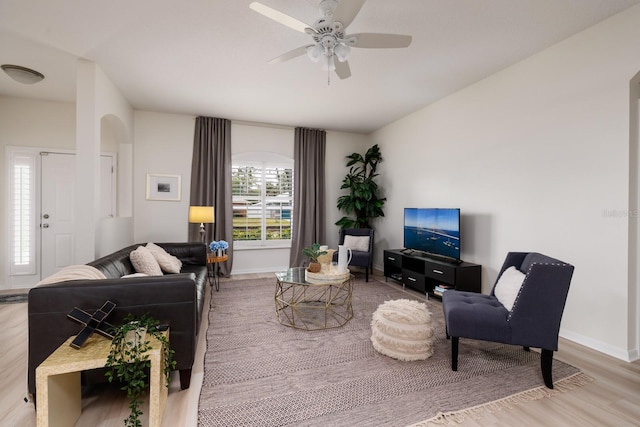 living room with light hardwood / wood-style floors and ceiling fan