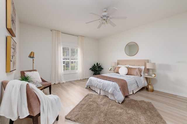 bedroom with light hardwood / wood-style floors and ceiling fan