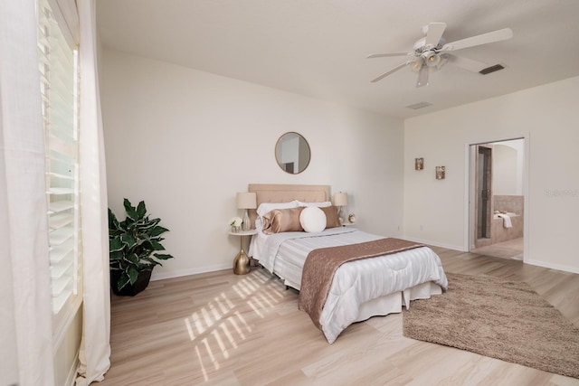 bedroom featuring ceiling fan, connected bathroom, and light wood-type flooring