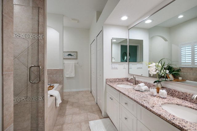 bathroom featuring vanity, separate shower and tub, and tile patterned floors