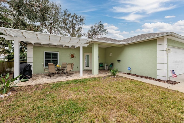 back of property with a yard, a pergola, and a patio