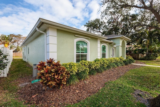 view of side of home featuring a lawn