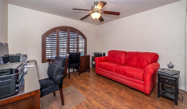 office area with ceiling fan, dark hardwood / wood-style floors, and a textured ceiling