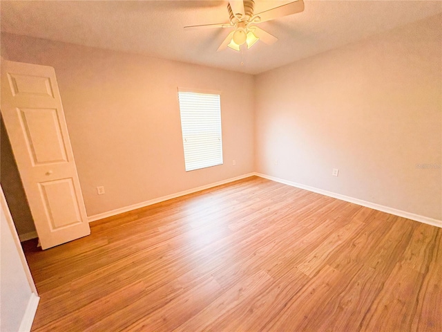 spare room with light hardwood / wood-style flooring and ceiling fan