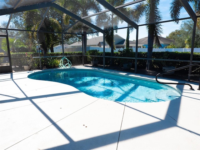 view of pool featuring a patio area and glass enclosure