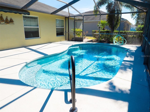 view of pool featuring a lanai and a patio