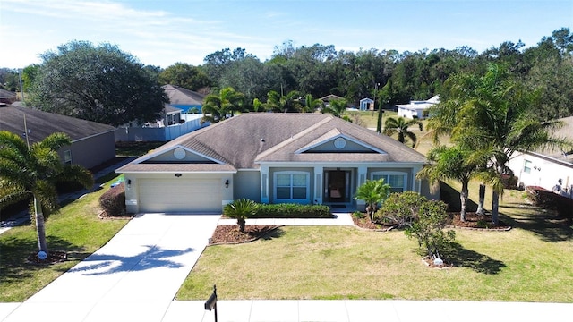 view of front of property featuring a garage and a front lawn