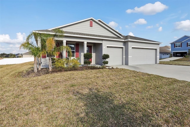 view of front of house featuring a garage and a front lawn