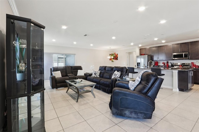 tiled living room featuring ornamental molding and sink