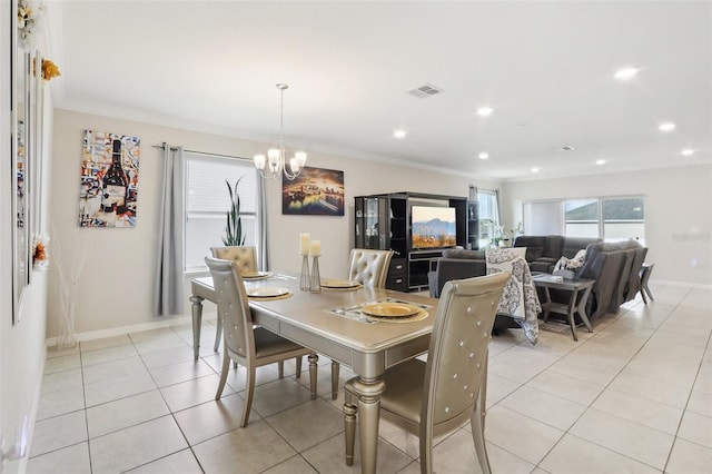 tiled dining space with crown molding and a notable chandelier