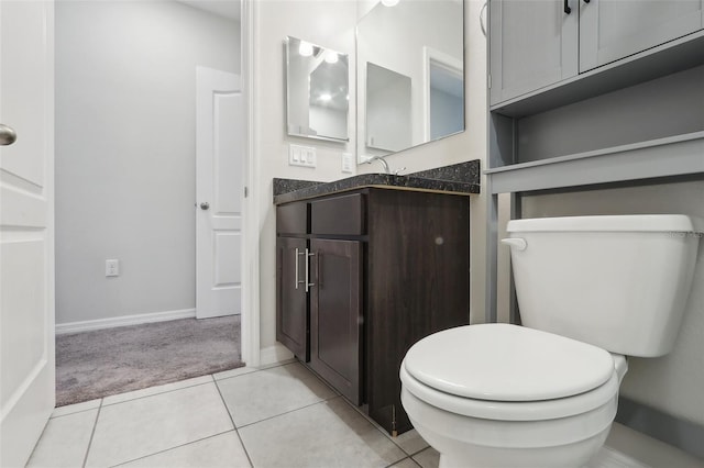 bathroom with tile patterned flooring, vanity, and toilet