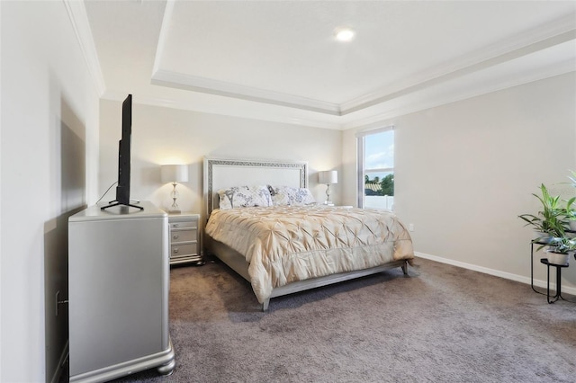 bedroom featuring crown molding, a tray ceiling, and dark colored carpet