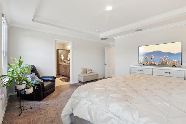 bedroom with a raised ceiling, crown molding, light colored carpet, and ensuite bath