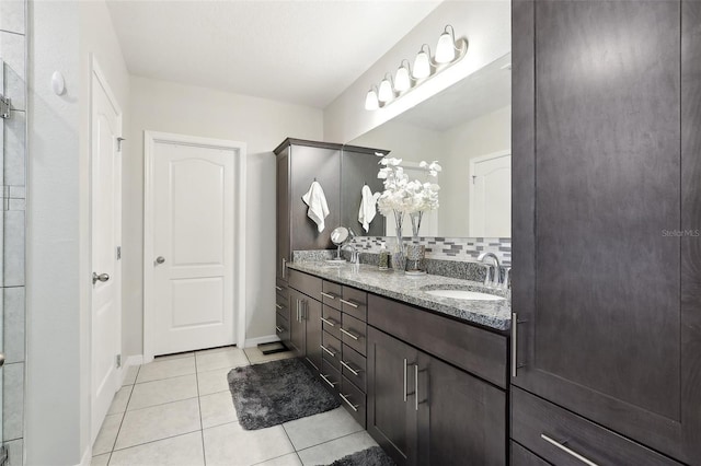 bathroom with tile patterned flooring, backsplash, and vanity