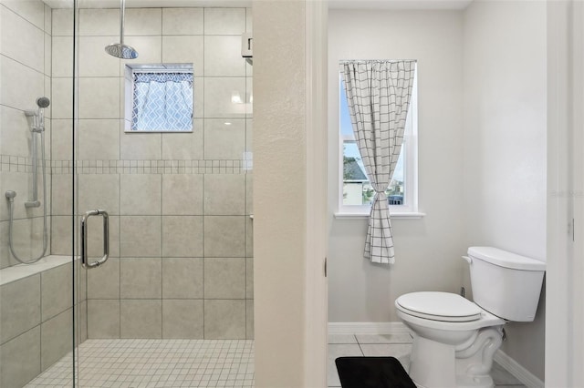 bathroom featuring walk in shower, tile patterned floors, and toilet