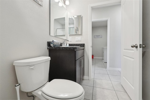 bathroom with tile patterned flooring, vanity, and toilet