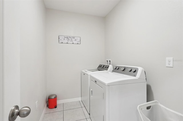 clothes washing area with light tile patterned floors and independent washer and dryer