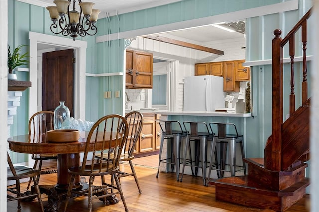 dining room featuring hardwood / wood-style flooring and a chandelier