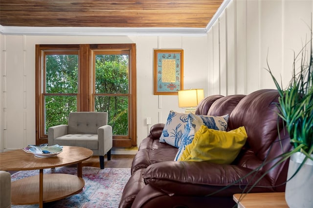 living area featuring crown molding, wood-type flooring, and wooden ceiling