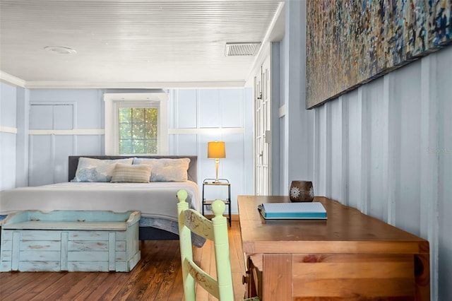 bedroom with dark hardwood / wood-style floors