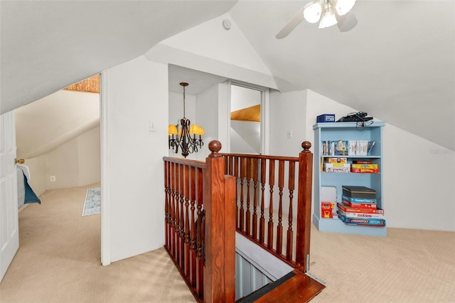 bonus room featuring ceiling fan with notable chandelier, vaulted ceiling, and light carpet