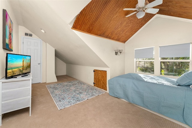 carpeted bedroom with ceiling fan, vaulted ceiling, and wooden ceiling