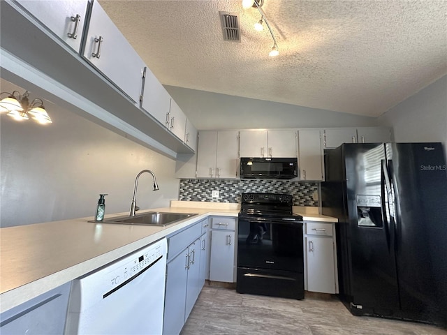 kitchen with sink, tasteful backsplash, vaulted ceiling, light hardwood / wood-style flooring, and black appliances