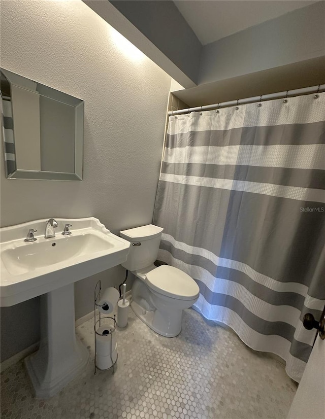 bathroom with tile patterned flooring and toilet