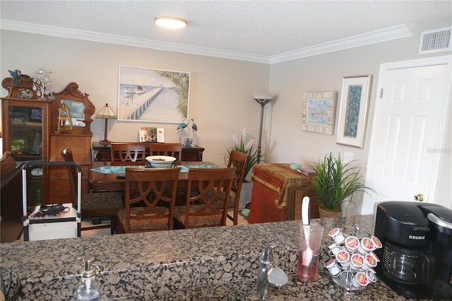 dining area featuring crown molding and a textured ceiling