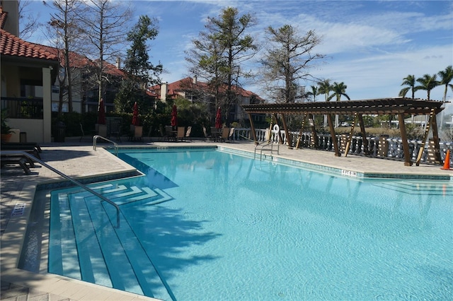 view of swimming pool with a pergola