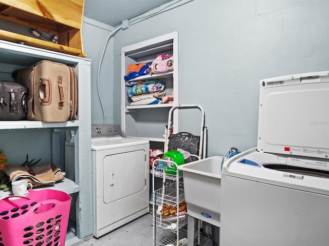 laundry area with washing machine and dryer, laundry area, and a sink