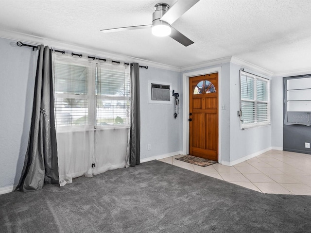 foyer featuring a healthy amount of sunlight, light colored carpet, a wall unit AC, and light tile patterned flooring