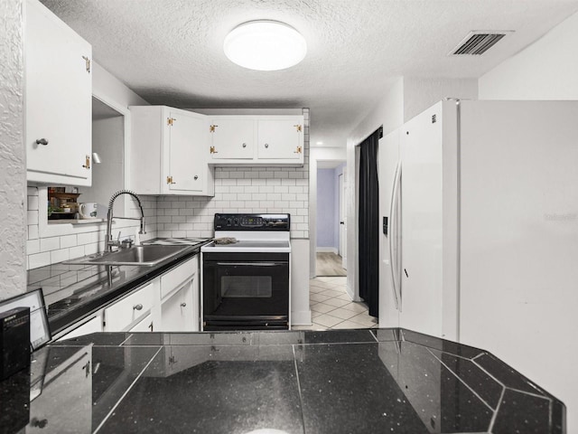 kitchen with electric range, a sink, visible vents, white cabinetry, and dark countertops