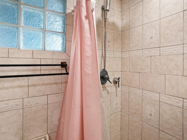 full bathroom with tiled shower