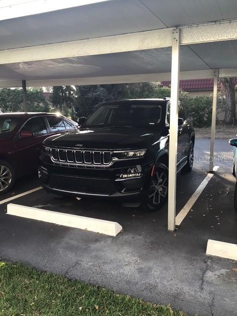 view of vehicle parking featuring a carport