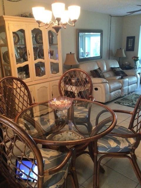 dining space featuring an inviting chandelier and tile patterned floors