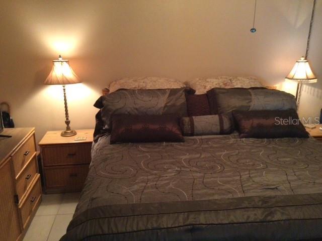 bedroom with light tile patterned floors