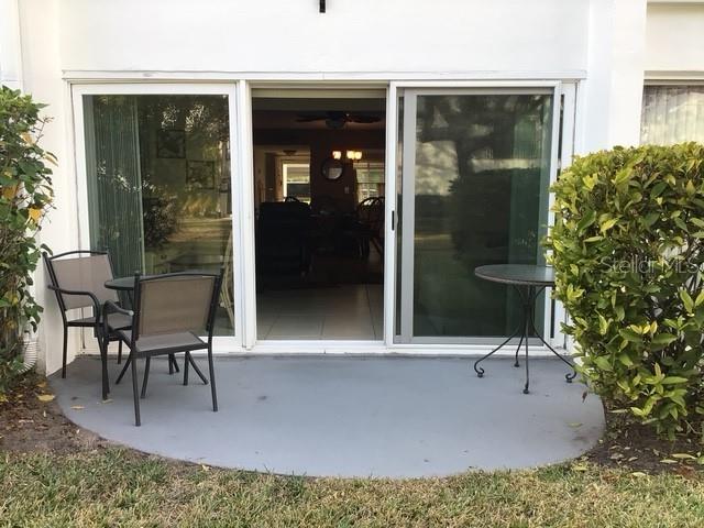 view of exterior entry featuring a patio area