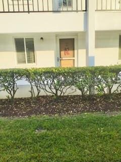 entrance to property with stucco siding and a balcony