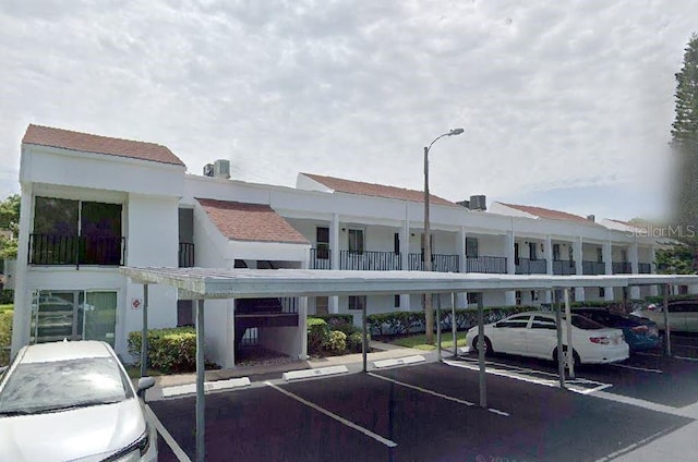 view of building exterior featuring covered parking